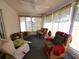 Bright sunroom with ample seating and large windows at 5958 Sw 102Nd Ln, Ocala, FL 34476