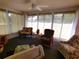 Relaxing sunroom featuring comfortable seating and natural light at 5958 Sw 102Nd Ln, Ocala, FL 34476