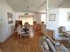 Bright dining room with wood floors and glass-top table, seating six at 5958 Sw 102Nd Ln, Ocala, FL 34476