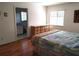 Bedroom with wood floors, dresser, and ensuite bathroom access at 5958 Sw 102Nd Ln, Ocala, FL 34476