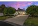Evening view of a two-story house with landscaping and driveway at 3051 Sw 41St Pl, Ocala, FL 34474