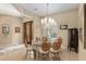 Formal dining room with glass top table, chandelier, and wicker chairs at 3051 Sw 41St Pl, Ocala, FL 34474
