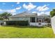 Landscaped backyard with green grass and pool enclosure at 3051 Sw 41St Pl, Ocala, FL 34474