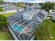 Aerial view of house with solar panels and screened pool at 3051 Sw 41St Pl, Ocala, FL 34474