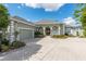 Green house exterior with circular driveway and landscaping at 3051 Sw 41St Pl, Ocala, FL 34474