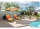 Enjoy this pool and patio area with lounge chairs and umbrella at 3051 Sw 41St Pl, Ocala, FL 34474