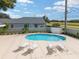 Community pool with lounge chairs and cabana at 3051 Sw 41St Pl, Ocala, FL 34474