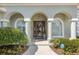 Elegant front door entryway with arched columns and landscaping at 3051 Sw 41St Pl, Ocala, FL 34474