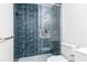 Walk-in shower with blue tile and glass enclosure at 1709 Ne 28Th Pl, Ocala, FL 34470