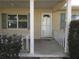 Covered front porch with white columns and a white door at 9002 Sw 96Th Ln # C, Ocala, FL 34481
