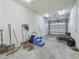 Spacious storage room with various gardening tools and hay bales at 10621 Sw 11Th Ter, Ocala, FL 34476