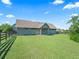Exterior view of a barn with lush lawn, offering plenty of space at 10621 Sw 11Th Ter, Ocala, FL 34476