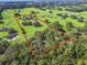 Estate property aerial view showcasing large home, lush green pastures, and surrounding land at 10621 Sw 11Th Ter, Ocala, FL 34476