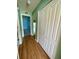 Light green hallway with wood flooring and closets at 10787 Sw 53Rd Cir, Ocala, FL 34476