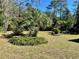 Landscaped backyard with tropical plants and lush grass at 10787 Sw 53Rd Cir, Ocala, FL 34476
