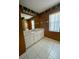 Bathroom with white vanity, tile floor and shower/tub combo at 10787 Sw 53Rd Cir, Ocala, FL 34476