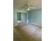 Light blue bedroom with mirrored closet doors and ceiling fan at 10787 Sw 53Rd Cir, Ocala, FL 34476