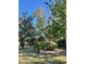 Well-lit yard with lush landscaping and trees at 10787 Sw 53Rd Cir, Ocala, FL 34476