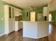 Kitchen with white cabinets, laminate flooring, and appliances at 10787 Sw 53Rd Cir, Ocala, FL 34476