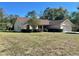 Single-story house with a large front yard and mature trees at 10787 Sw 53Rd Cir, Ocala, FL 34476