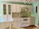 Kitchen boasts white cabinets and built-in microwave at 10787 Sw 53Rd Cir, Ocala, FL 34476