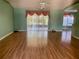 Bright living room with laminate wood floors and vaulted ceiling at 10787 Sw 53Rd Cir, Ocala, FL 34476