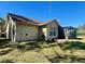 House exterior showcasing a screened porch and yard at 10787 Sw 53Rd Cir, Ocala, FL 34476
