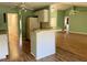Kitchen with island, white cabinets, and laminate floor at 10787 Sw 53Rd Cir, Ocala, FL 34476