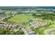 Aerial view of community showing homes, golf course, and lake at 3554 Nw 55Th Cir, Ocala, FL 34482