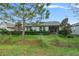 Home's backyard with screened patio and landscaping at 3554 Nw 55Th Cir, Ocala, FL 34482
