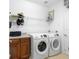 Convenient laundry room with washer, dryer, and storage shelves at 3554 Nw 55Th Cir, Ocala, FL 34482