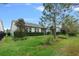 Home's backyard with screened patio and landscaping at 3554 Nw 55Th Cir, Ocala, FL 34482