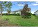 Home's backyard with screened patio and landscaping at 3554 Nw 55Th Cir, Ocala, FL 34482