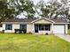 Charming single story home with blue shutters and a white garage door at 3011 Nw 3Rd Ter, Ocala, FL 34475