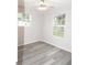 Bright bedroom with two windows and wood-look flooring at 3011 Nw 3Rd Ter, Ocala, FL 34475