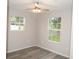 Bright bedroom featuring two windows and ceiling fan at 3011 Nw 3Rd Ter, Ocala, FL 34475