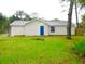 House exterior showcasing a spacious backyard at 3011 Nw 3Rd Ter, Ocala, FL 34475