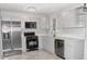 Modern kitchen featuring gray cabinets, granite countertops, and stainless steel appliances at 3011 Nw 3Rd Ter, Ocala, FL 34475