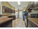 Modern kitchen with dark wood cabinets and granite countertops at 13899 Sw 89Th St, Dunnellon, FL 34432