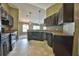 Modern kitchen with dark wood cabinets and granite counters at 13899 Sw 89Th St, Dunnellon, FL 34432