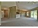 Open living room featuring a kitchen with an island and access to backyard at 13899 Sw 89Th St, Dunnellon, FL 34432