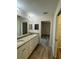 Double vanity bathroom with granite countertop and access to closet at 12 Pecan Run Radl, Ocala, FL 34472