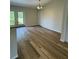 Bright dining room with wood-look floors and access to backyard at 12 Pecan Run Radl, Ocala, FL 34472