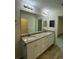 Double vanity bathroom with granite countertop and access to closet at 12 Pecan Run Radl, Ocala, FL 34472