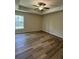 Spacious bedroom with wood-look flooring and ceiling fan at 12 Pecan Run Radl, Ocala, FL 34472
