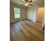 Bright bedroom with wood-look floors and ceiling fan at 12 Pecan Run Radl, Ocala, FL 34472