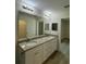 Double vanity bathroom with granite countertop and access to closet at 12 Pecan Run Radl, Ocala, FL 34472