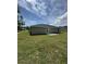 Rear view of house showing back patio and grassy yard at 12 Pecan Run Radl, Ocala, FL 34472