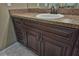 Bathroom vanity with dark wood cabinets and a granite countertop at 12472 Sw 85Th Pl, Dunnellon, FL 34432