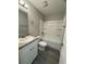 Modern bathroom with a vanity, toilet, and bathtub at 6044 Nw 65Th Pl, Ocala, FL 34482